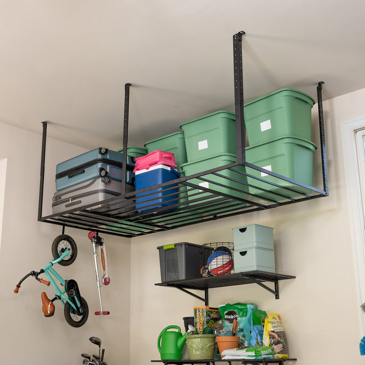 Overhead ceiling rack with bins and a kids bike hanging from a hook below