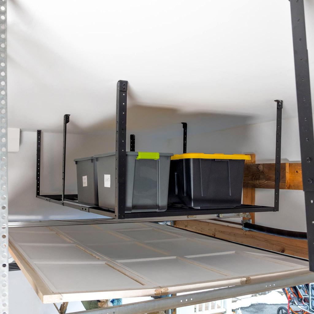 Overhead rack holding bins in the space above a garage door