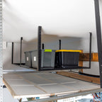 Overhead rack holding bins in the space above a garage door