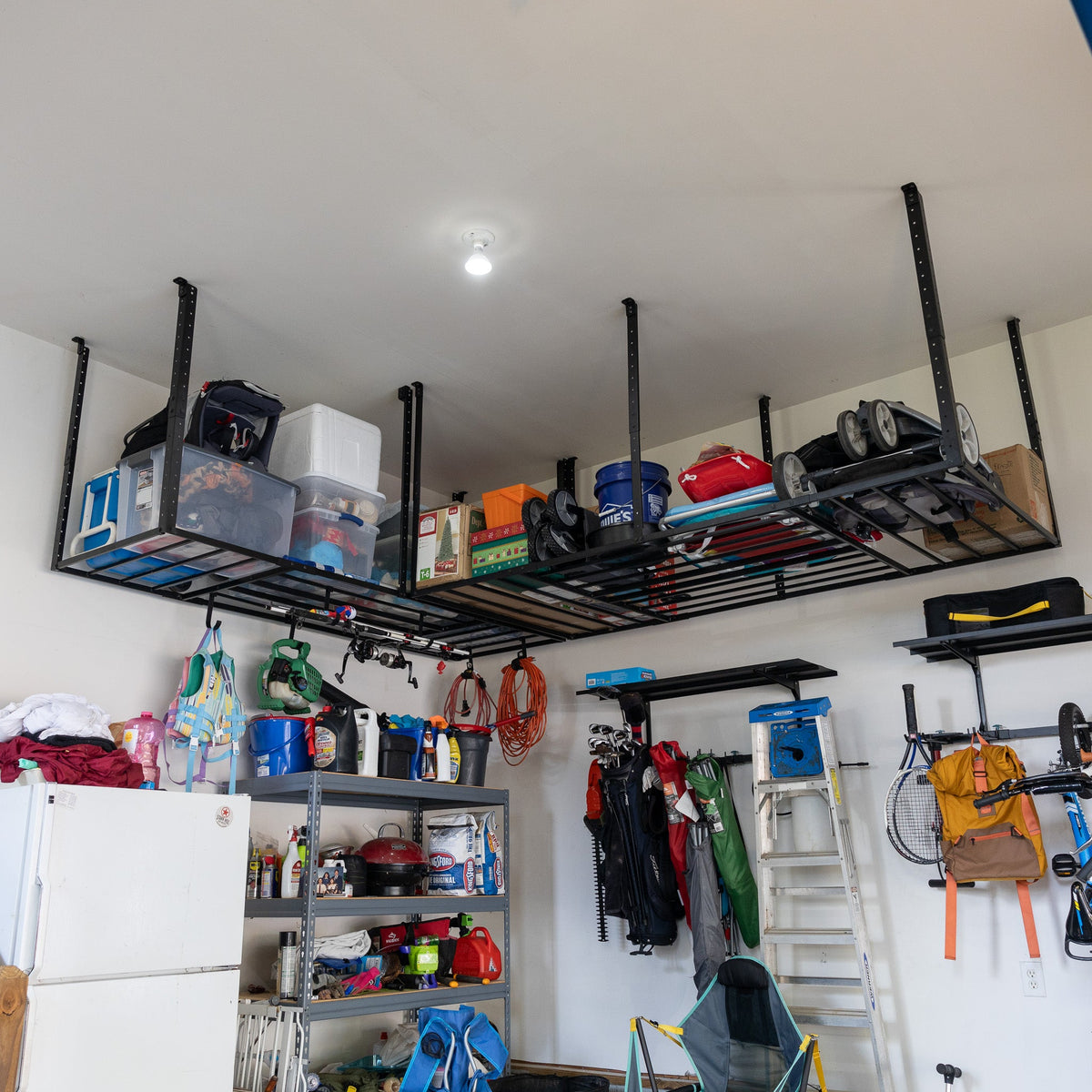 Overhead ceiling rack holding bins above garage shelving, sports gear and a ladder