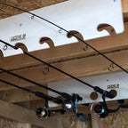 Fishing rods stored on wood racks under a shed ceiling