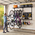 Woman hanging a bike on the G-Storage Pro wall system holding bikes, helmets, tools and bins