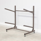 Empty mud-colored 2-level kayak rack with wheels