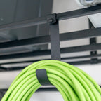 Close-up of an extension cord hanging from a hook under the overhead rack