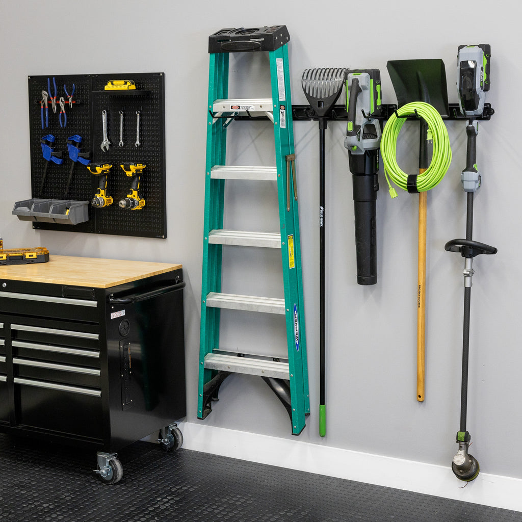 48-inch wall organizer holding a ladder, shovels, a hose and yard tools beside a workbench