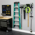 48-inch wall organizer holding a ladder, shovels, a hose and yard tools beside a workbench