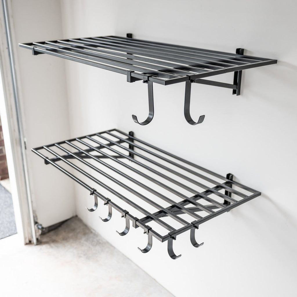 Two empty black 2 x 4 ft wall shelves with hooks underneath