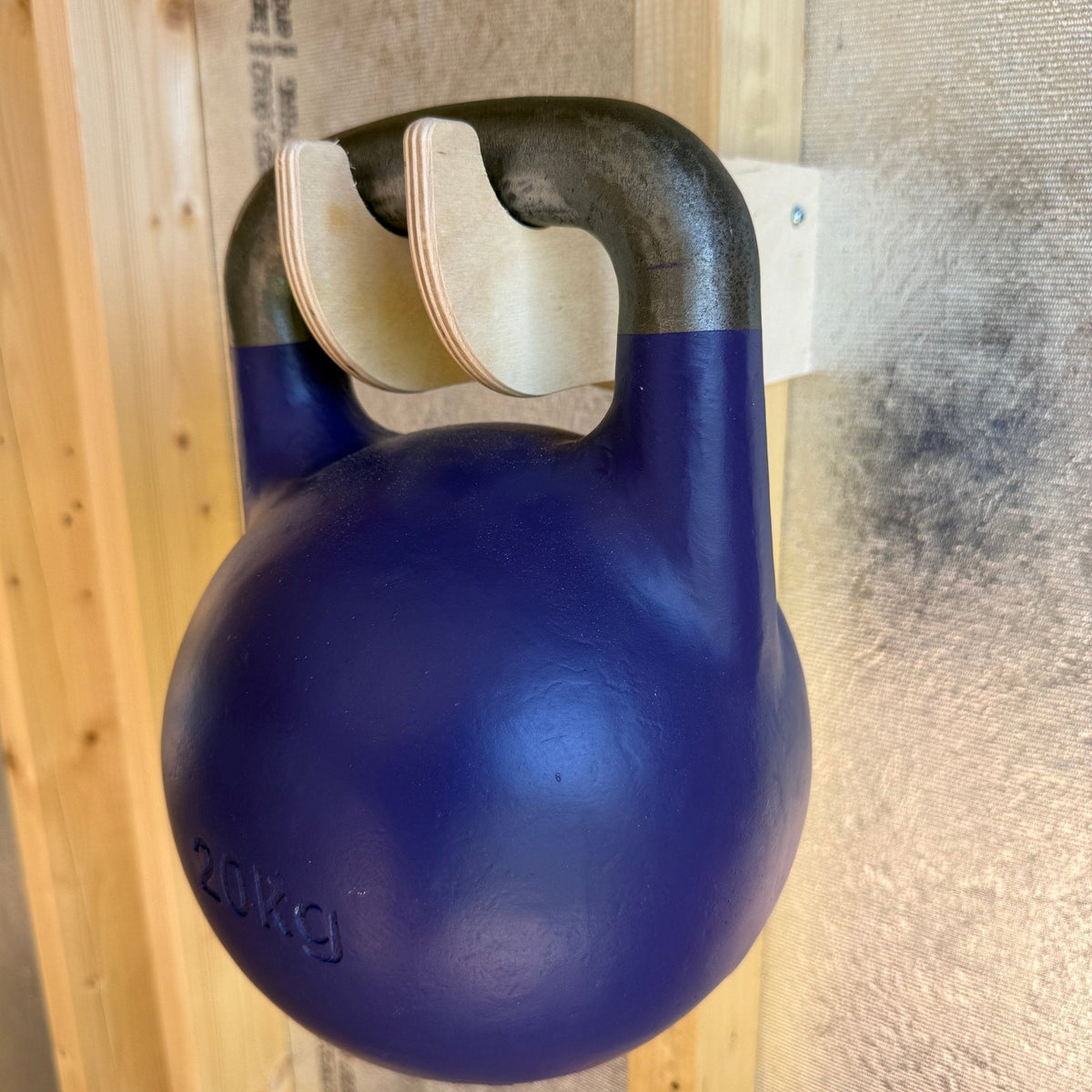 Wood garden tool hook holding a kettlebell