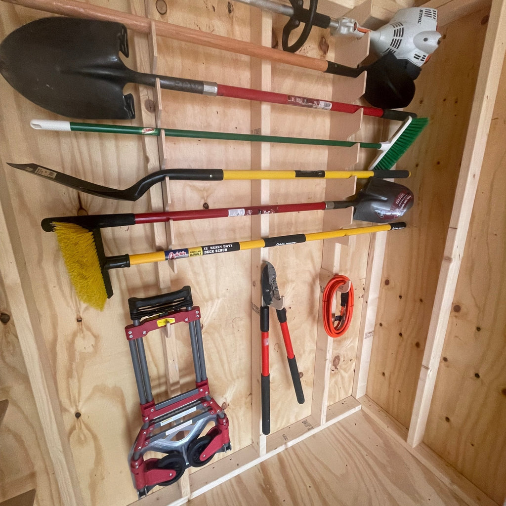 Garden tool rack holding shovels, a broom and a hand truck in a shed
