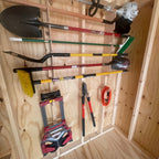 Garden tool rack holding shovels, a broom and a hand truck in a shed
