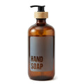 Amber glass hand soap dispenser with black pump and bamboo collar