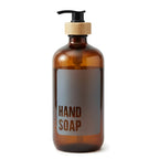 Amber glass hand soap dispenser with black pump and bamboo collar