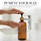 Hand using the pump on the amber hand soap bottle