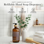 Refillable amber glass hand soap dispenser on a bathroom counter