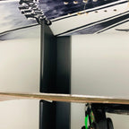 Close-up of a snowboard rack rail holding a board