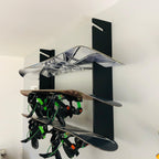 Snowboard wall rack holding three snowboards with bindings