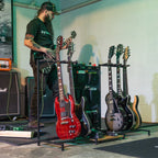 Musician taking a guitar from the rack in a studio
