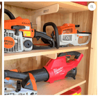 Shed shelves holding a chainsaw, leaf blower and hedge trimmer