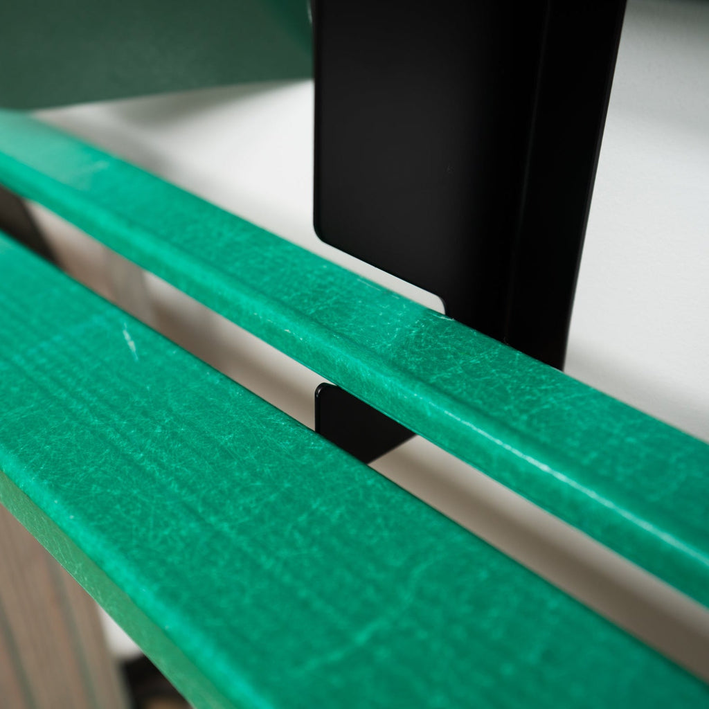 Close-up of green tool handles held in the black organizer slots