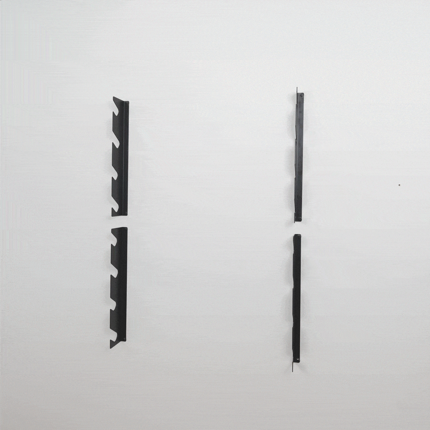 Two empty 8-level tool organizer brackets mounted on a wall
