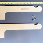 Two wood lawn chair hooks with mounting screws and a ruler showing their size