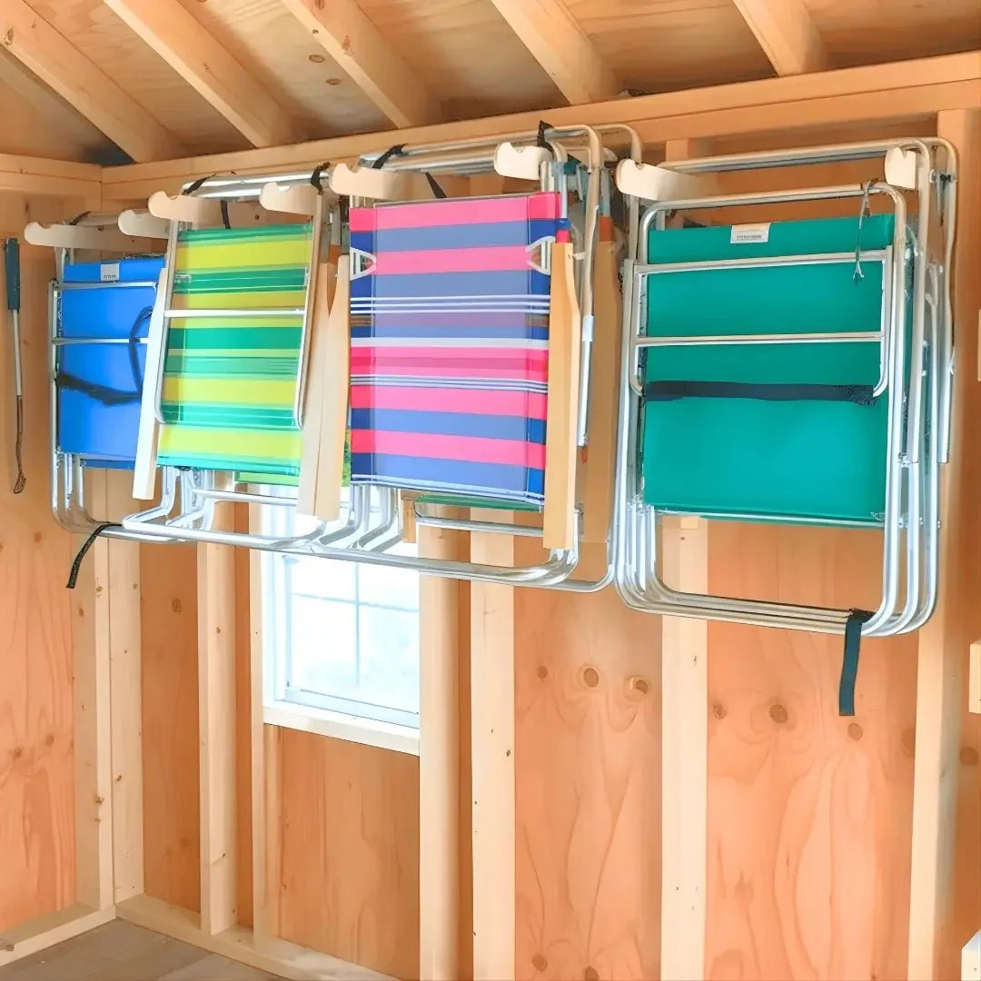 Lawn chair hooks holding four folding beach chairs on a shed wall