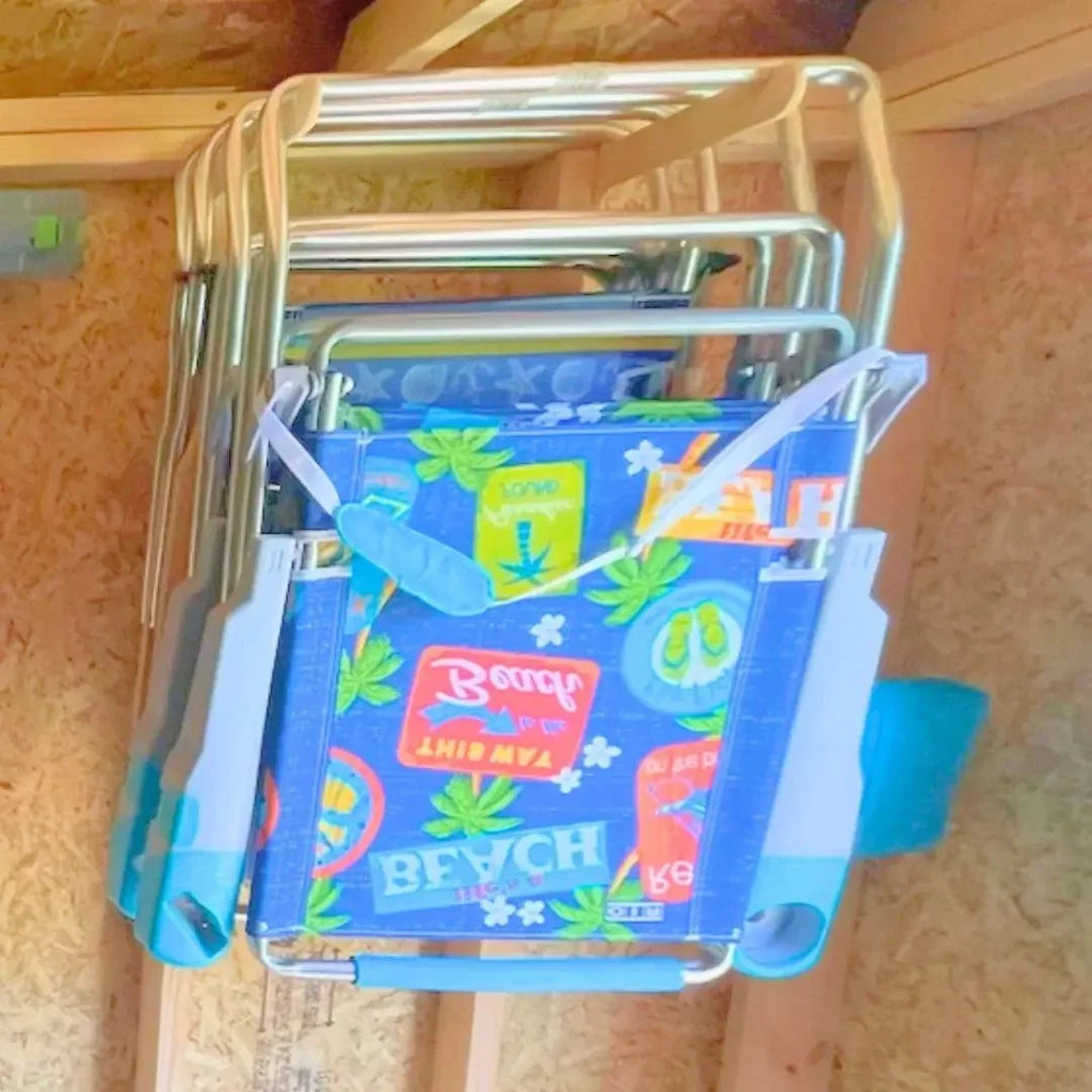 Folding beach chairs hanging on lawn chair hooks