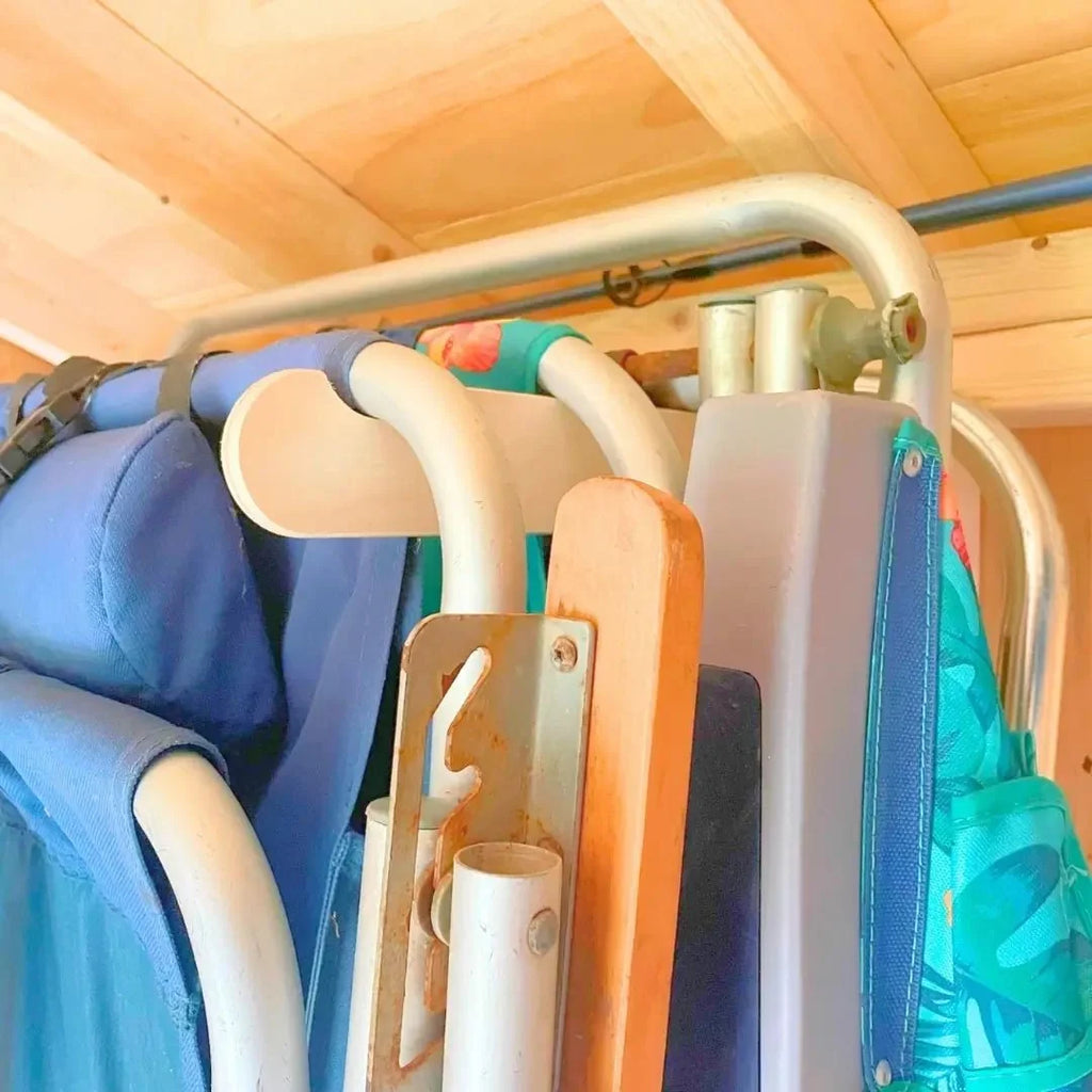 Folding chairs stored on lawn chair hooks, side view