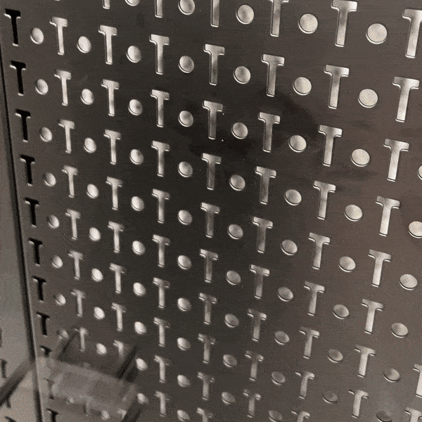 Close-up of the black steel PRO pegboard surface with locking hooks