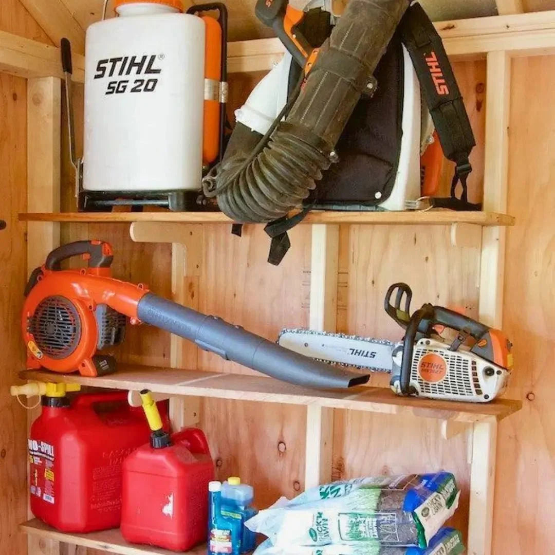Shed shelves holding a backpack blower, chainsaw and gas cans