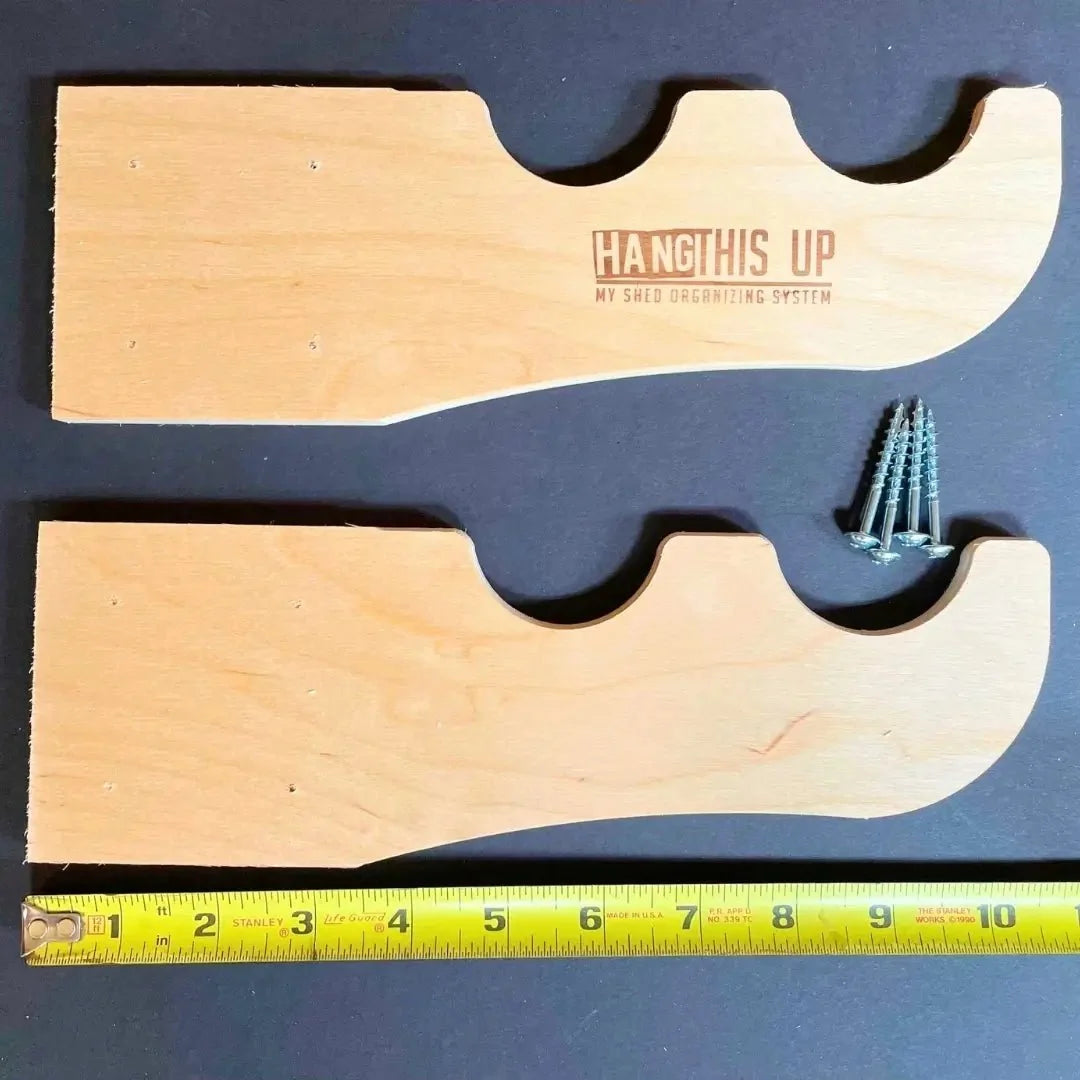 Wood hooks with mounting screws and a ruler showing their size