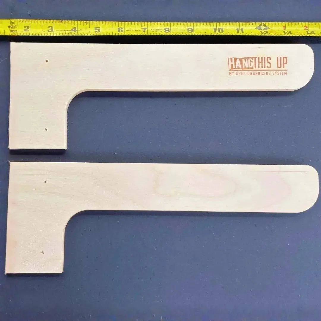 Two wood shelf brackets with a ruler showing their size