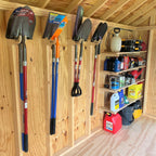 Shed wall with tools on hooks and supplies on shelves