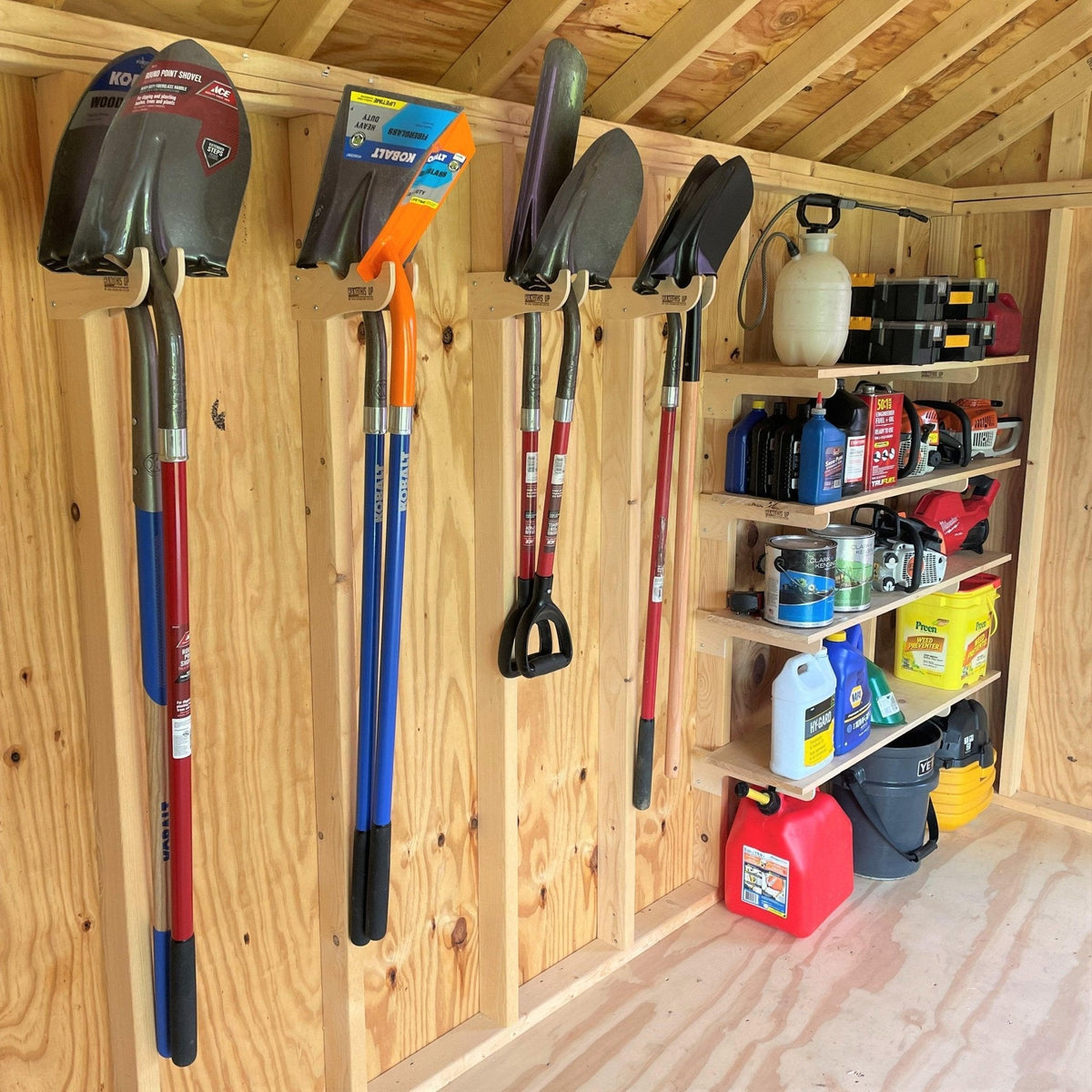 Shed wall with tools on hooks and supplies on shelves