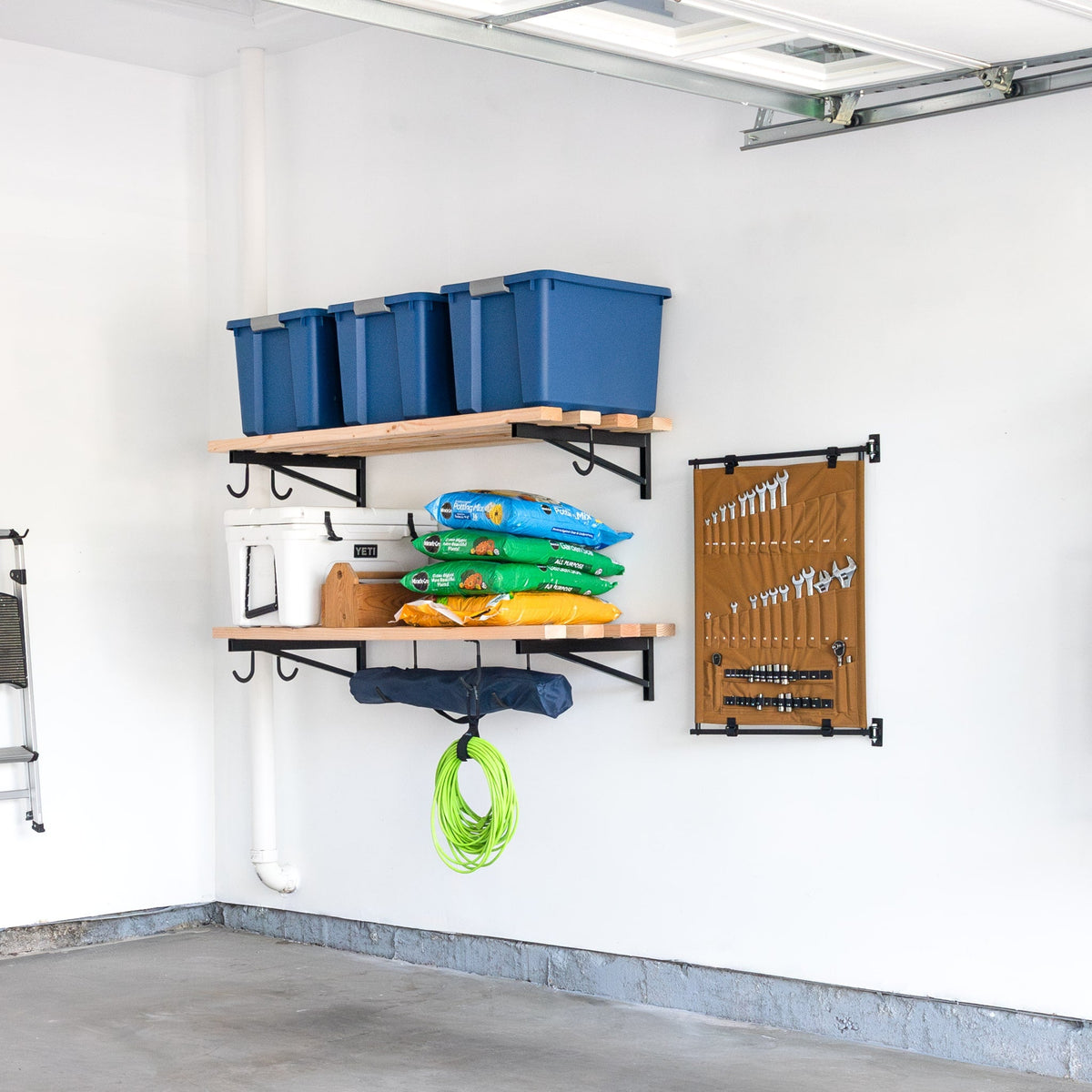 Tan Pivot Panel on a garage wall beside shelves of bins