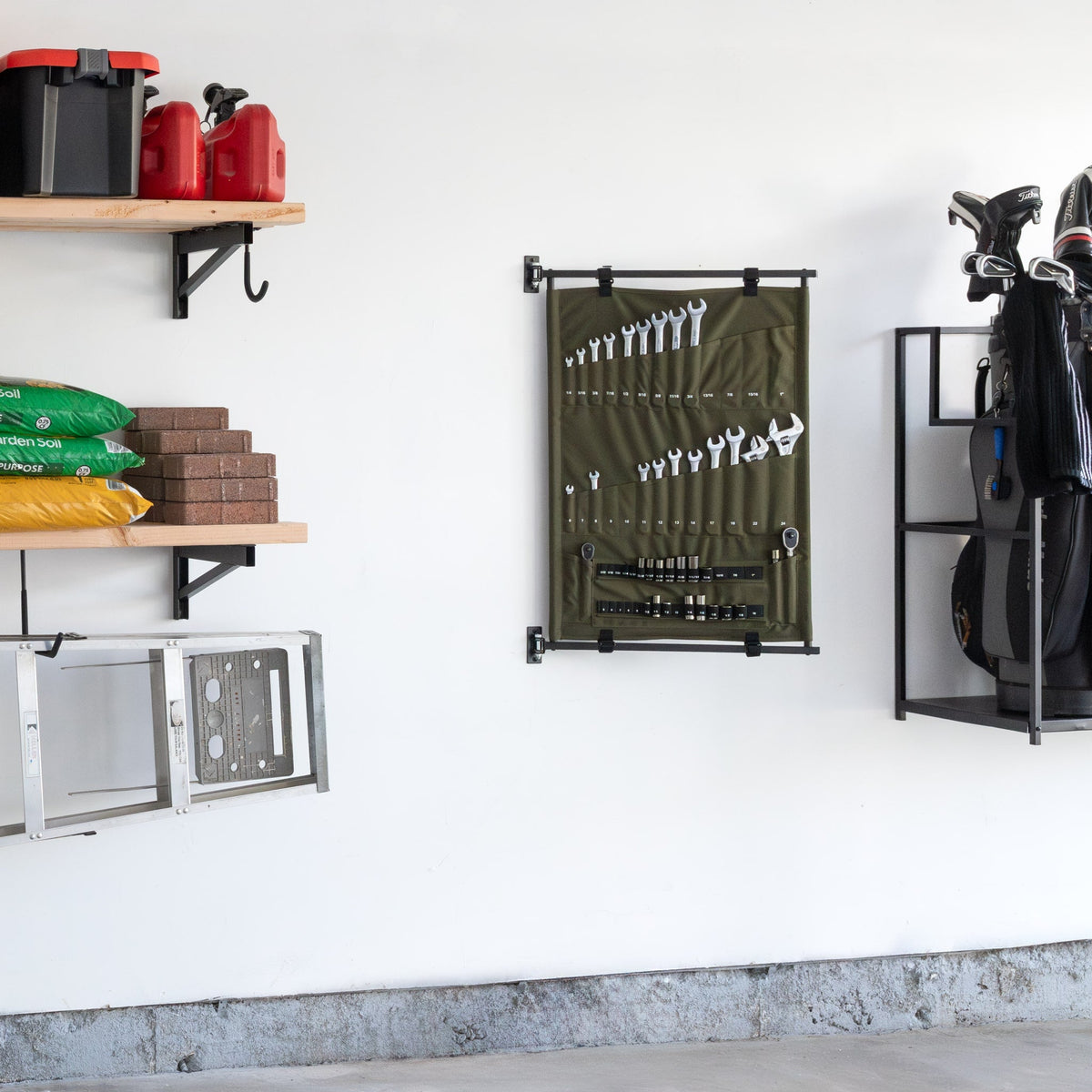 Green Pivot Panel on a garage wall beside shelves and a golf organizer