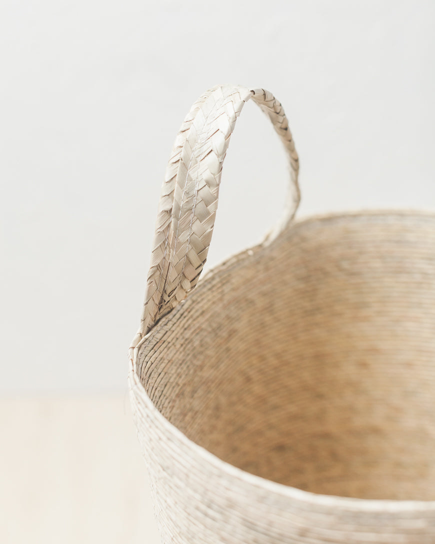 Close-up of the Prado basket's braided palm hanging loop