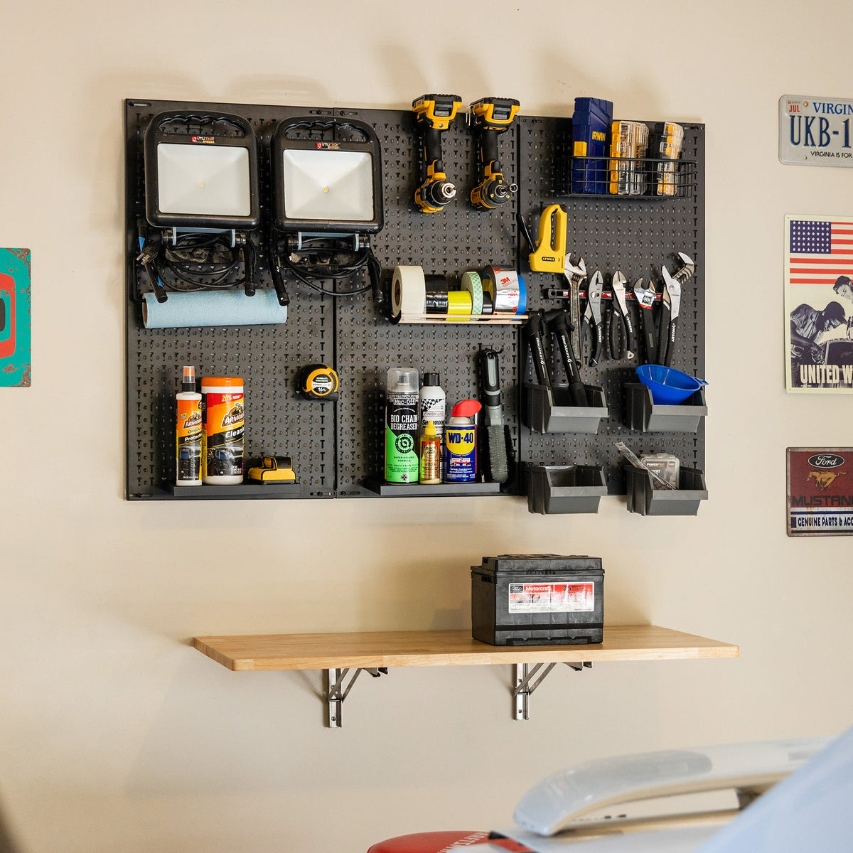 PRO pegboard with tools and supplies mounted above a wooden wall shelf