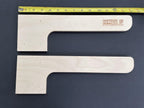 Two wood shed shelf brackets with a ruler showing their length