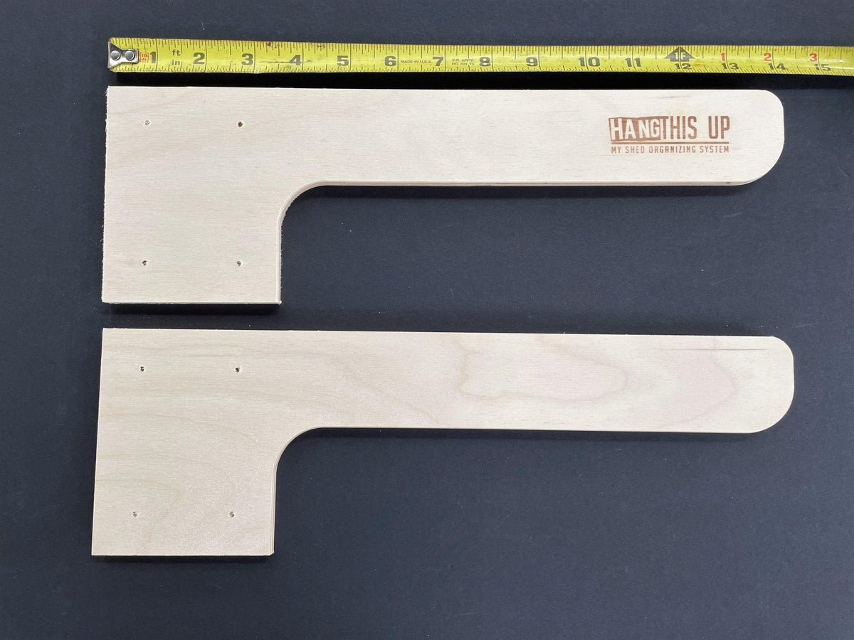 Two wood shed shelf brackets with a ruler showing their length