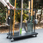 Hands rolling the Shovel Shuttle cart loaded with tools
