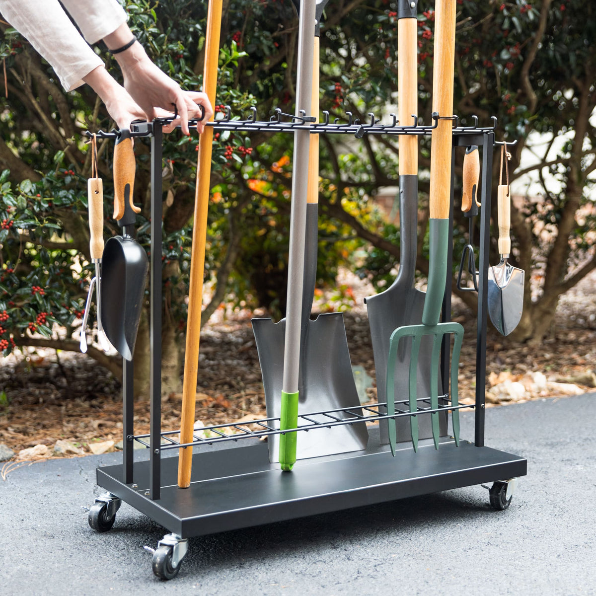 Hands rolling the Shovel Shuttle cart loaded with tools