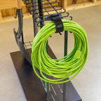 Close-up of a garden hose hanging on the cart side hook