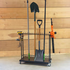 Shovel Shuttle rolling cart holding shovels, a rake and a hedge trimmer