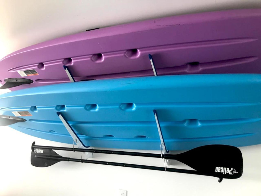 Two paddleboards and a paddle stored on the SUP rack