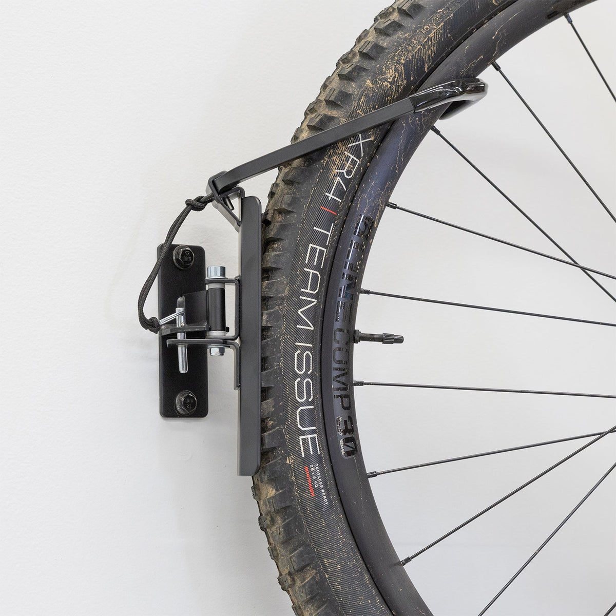 Close-up of a tire held by the swivel hook, side view