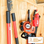 Wood hooks holding loppers and a hedge trimmer