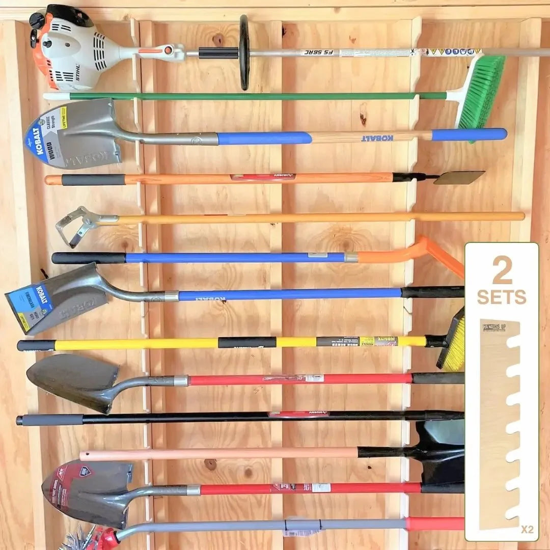 Garden tool racks holding long-handled tools on a shed wall