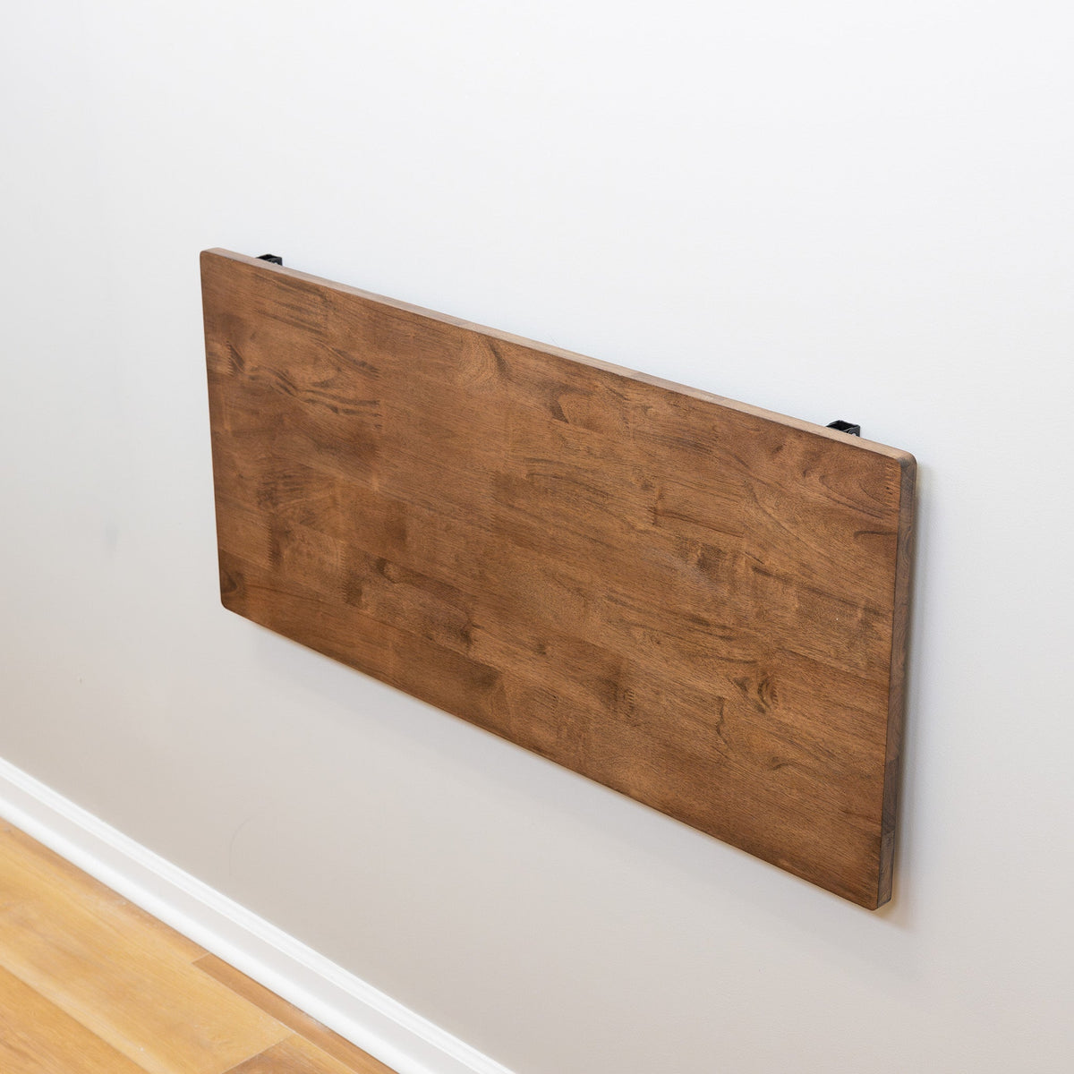Dark wood workbench folded flat against the wall