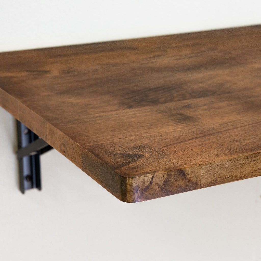 Close-up of the dark wood top and black folding bracket